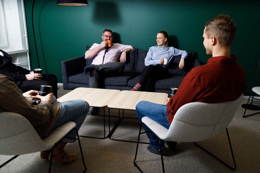 Employees drinking coffee on couches