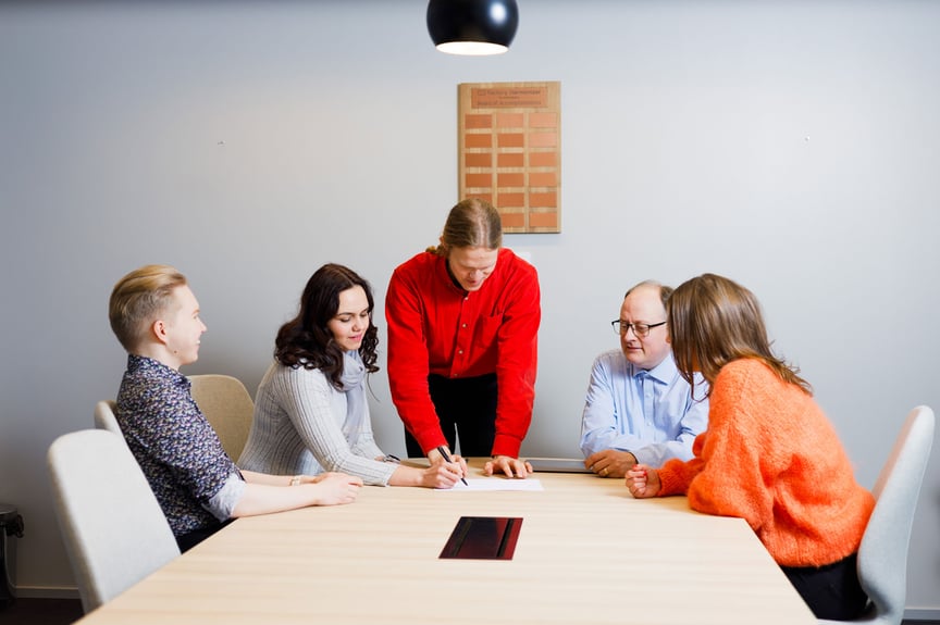 Group working together sitting around a table