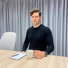 Image of Leo sitting at a desk