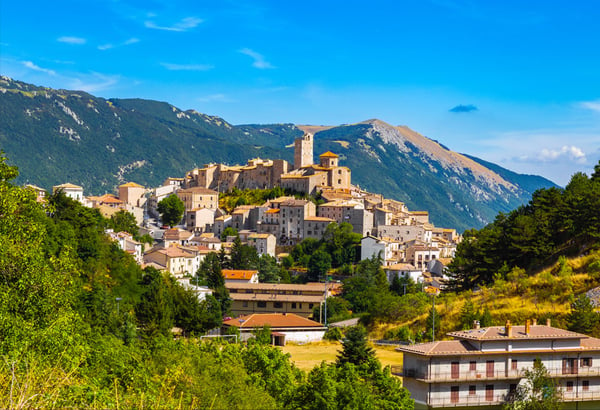 Village in Italy surrounded by mountains and trees